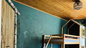 A bunk bed with a wooden frame and a small window, set against a teal wall with a wooden ceiling. - Apartment in the heart of the Dessoubre valley (Battenans-Varin)