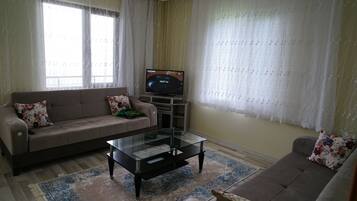 Family Suite, Lake View | Living area | TV