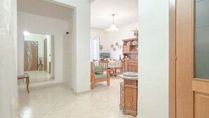 A spacious kitchen with wooden cabinets, a dining table, and chairs. - SV - Moroni (Savona)
