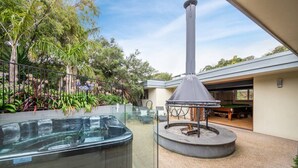 A hot tub, a fire pit, and a poolside area with a covered seating area and a view of the surrounding garden. - Yera Coastal Homestead with Tennis Court & Spa (Rye)