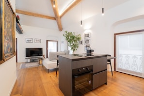 A modern kitchen with a built-in oven, a dining area with a table and chairs, and a large window with a view. - The Space Arena@100m (Verona)