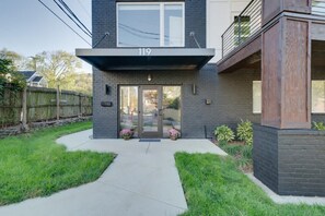 A modern two-story building with a flat roof, a balcony on the upper floor, and a visible address number '119'. - Sun-Filled West End • Sleeps 8 + 2 Parking Spots (Nashville)