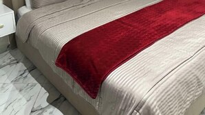 A bed with a headboard, two bedside tables, and a red blanket. - Clima 2BR| 2 min from Tangier's Grand Stadium (Tanger)