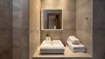 Deluxe Studio | Bathroom | Shower, hair dryer, towels, soap