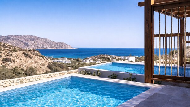 A pool with clear blue water, a wooden pergola, and a view of the sea and hills. - Ramnus Karpathos Suites (Karpathos)