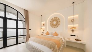 A modern bedroom with a large bed, a curved glass door, and a minimalist design. - 2BR Bali Villa Near Uluwatu Surf & Beach Clubs (South Kuta)