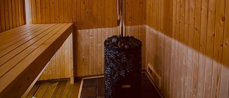 Sauna, jonka seinät ja penkit ovat tehty puusta.