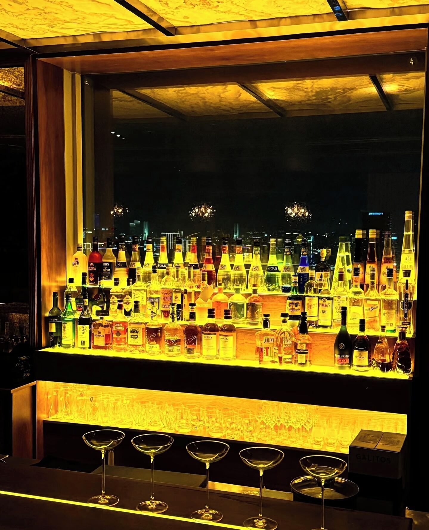 A bar with a variety of liquor bottles and glasses.