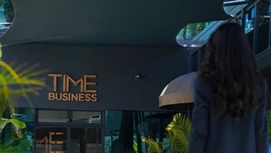 Un edificio moderno con un cartello che riporta la scritta "TIME BUSINESS".