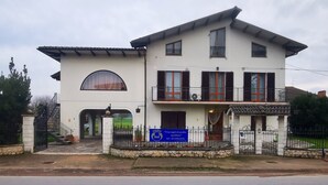 A two-story building with a balcony, a large arched window, and a signboard. - Paradise B&B. Your Exclusive Refuge in Castiglione del Lago! (Panicarola)
