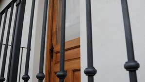 A white building with a wooden door and black metal railings. - The Rural Hostel in Mombeltrán, Ávila, Tiétar Valley (Mombeltrán)