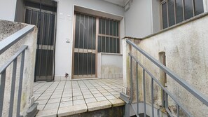 A narrow stairway with metal railings leading to a building entrance. - Beachside Apartment With Parking (Rosolina)