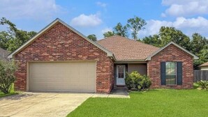 A two-story brick house with a garage, a front porch, and a well-maintained lawn. - Perfect 3-bedroom house with 2-car garage,AC and heat in welcoming Ponchatoula (Ponchatoula)