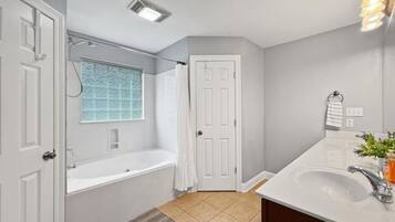 Jetted tub, hair dryer, towels, toilet paper