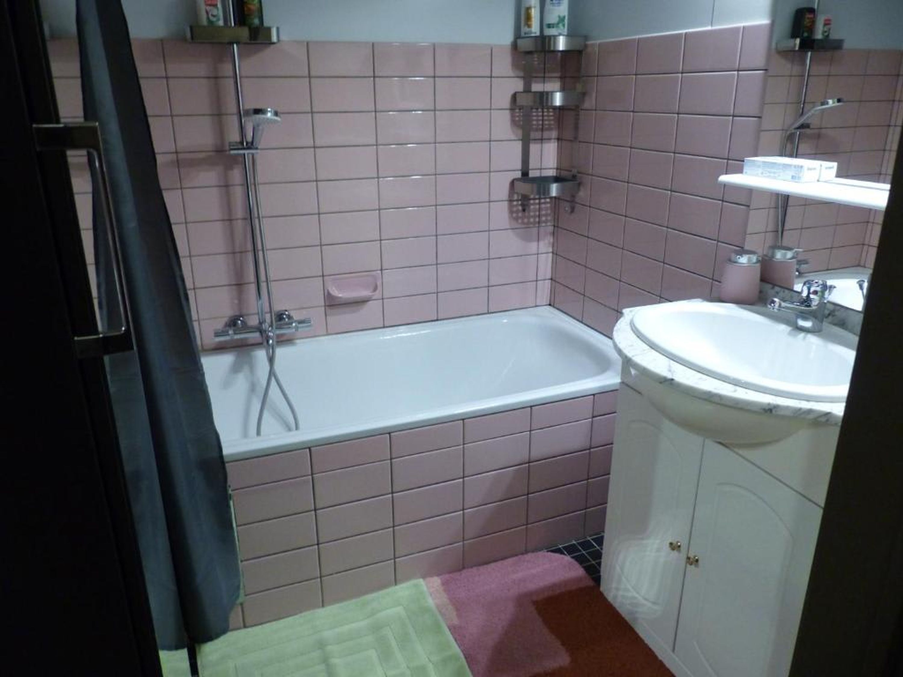 A bathroom with a bathtub, a sink, and a shower.