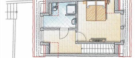 Un plan d’étage d’une chambre d’hôtel comprenant une salle de bain, un petit coin cuisine et un espace salon.