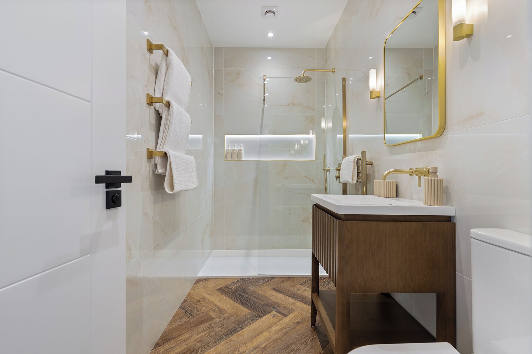 A modern bathroom with a shower, vanity, and a mirror.