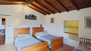 A bedroom with two wooden beds, a wooden ceiling, and a small window. - Beautiful private villa for 12 guests with private pool, WIFI, TV and pets allowed (Castel Di Casio)