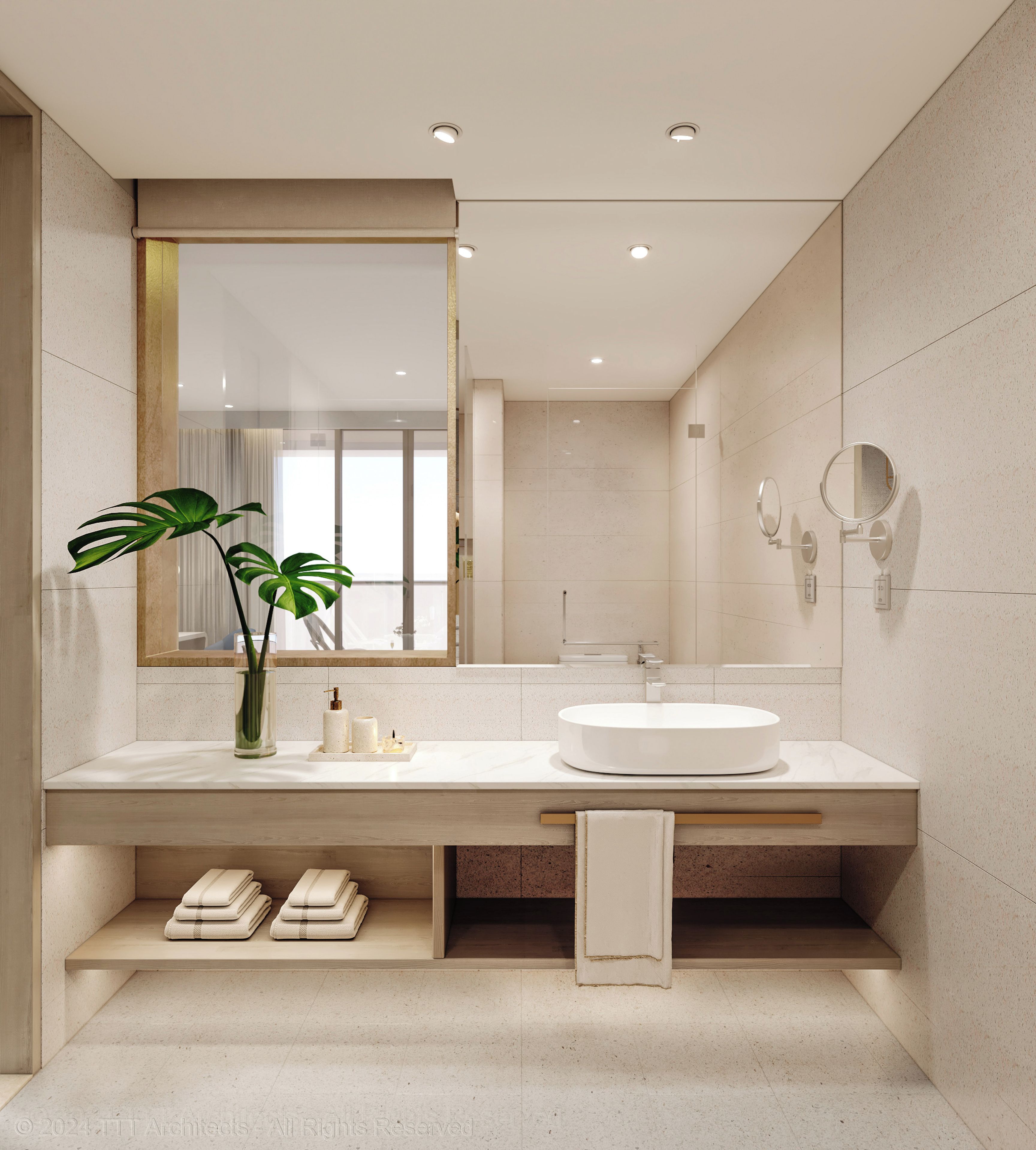 Un baño moderno con un espejo grande, un lavabo redondo y una planta en el tocador.
