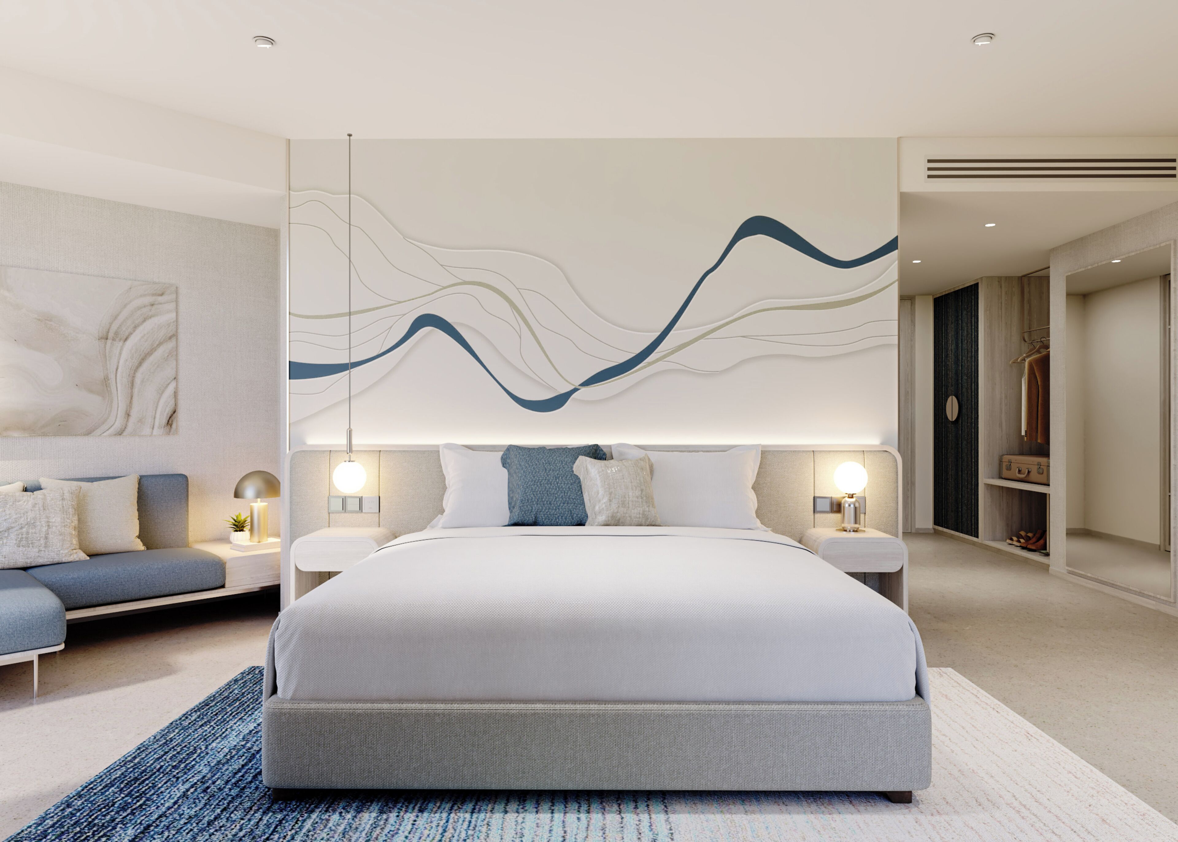 Une chambre moderne avec un grand lit, des tables de chevet, un canapé et une œuvre d’art murale.