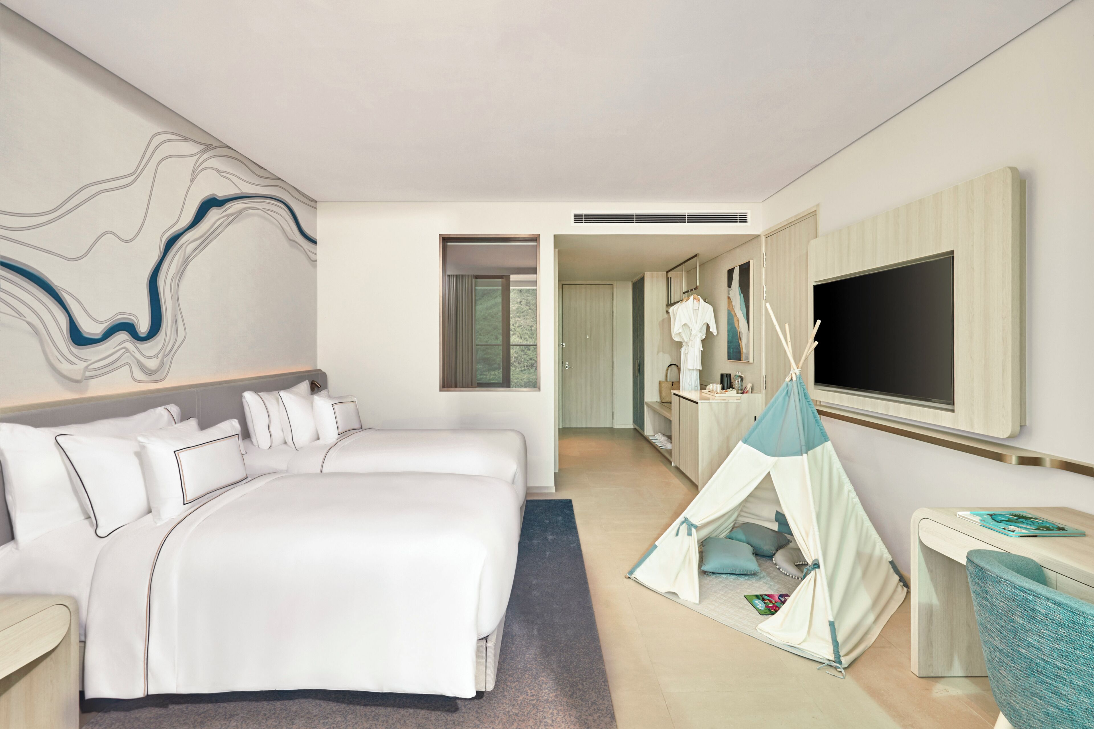 A hotel room with a bed, a tent, a TV, and a desk.