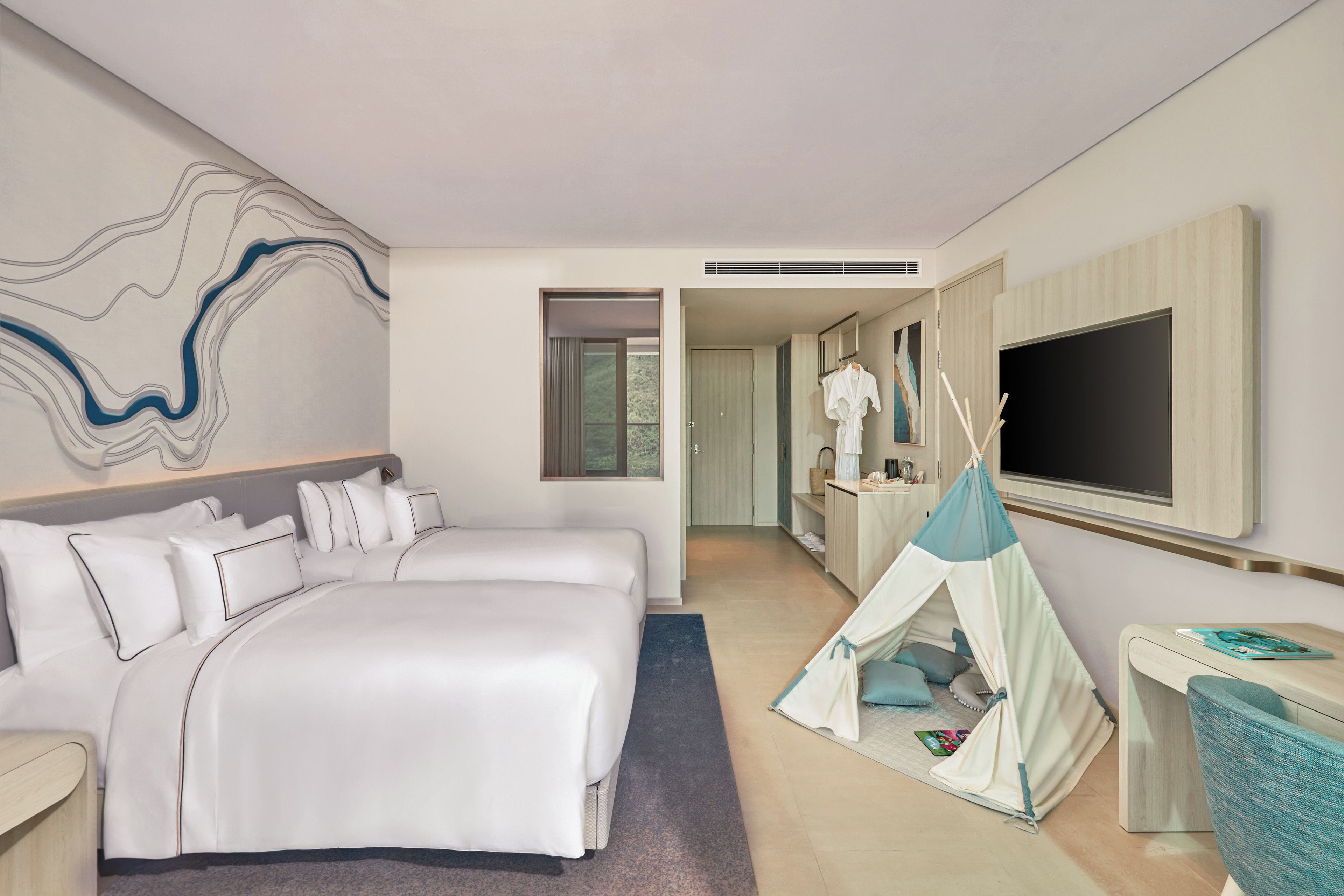 A hotel room with a large bed, a television, a wardrobe, and a tent-like structure.