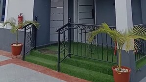 A modern two-story building with a flat roof, large windows, and a balcony. - Dwellux Apartment (Abuja)
