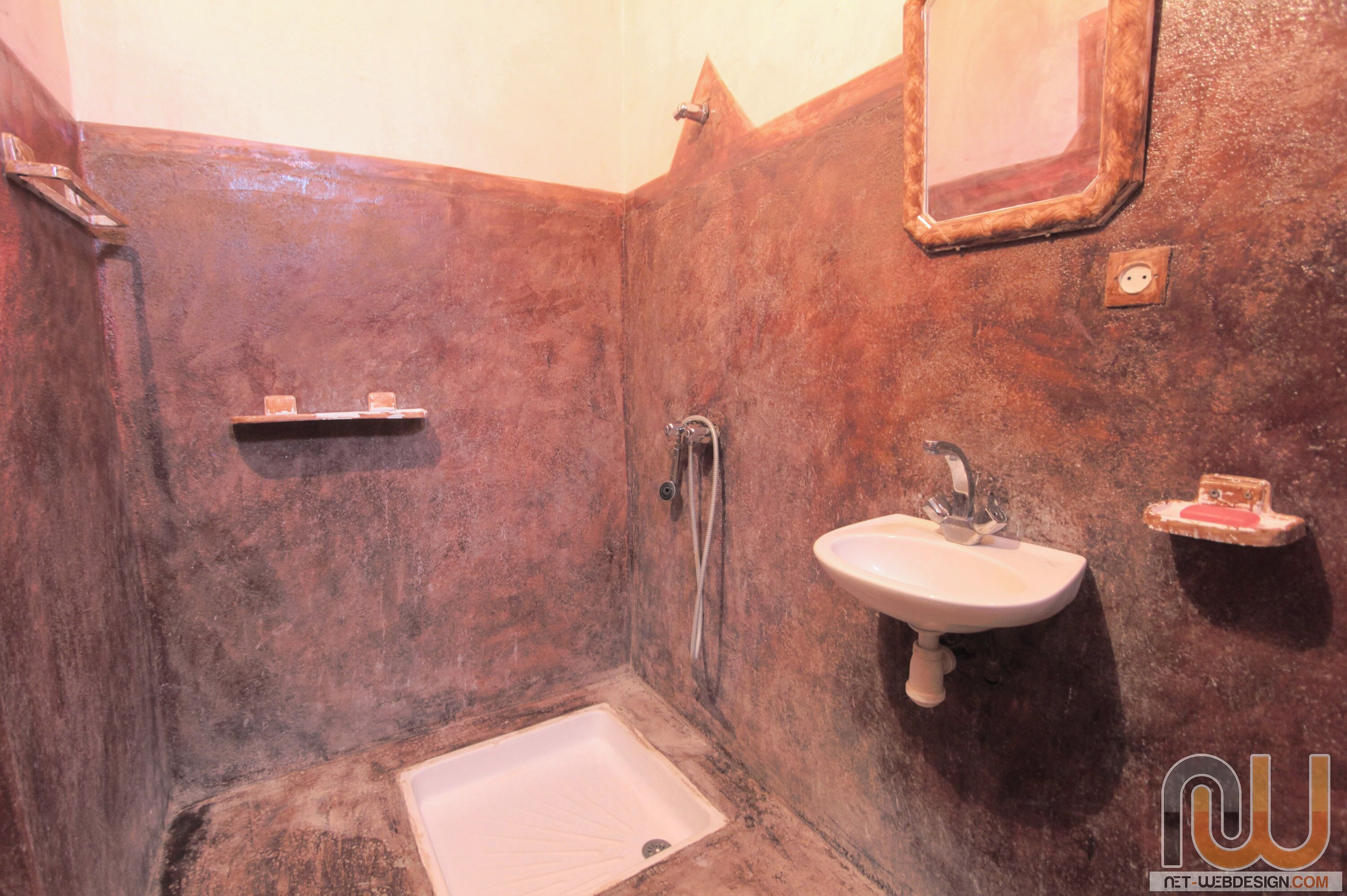 A bathroom with a bathtub, a sink, and a mirror.