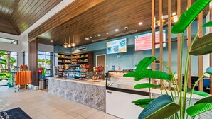 A modern reception area with a wooden ceiling, a counter with a glass display, and a menu board. - 16148 Palm Frond Avenue (Clermont)