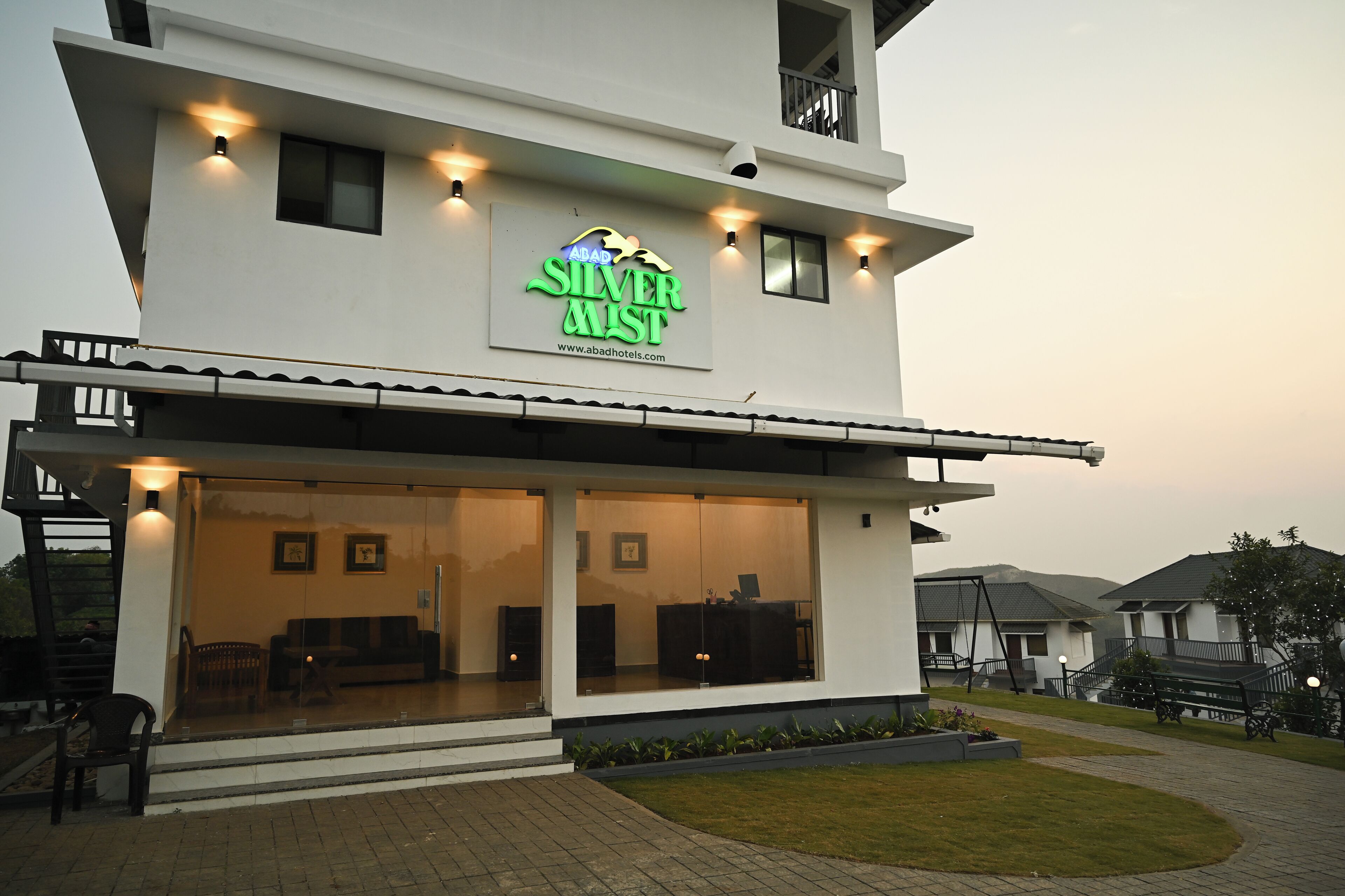 A modern hotel with a prominent sign reading "ABAD SILVER MIST".
