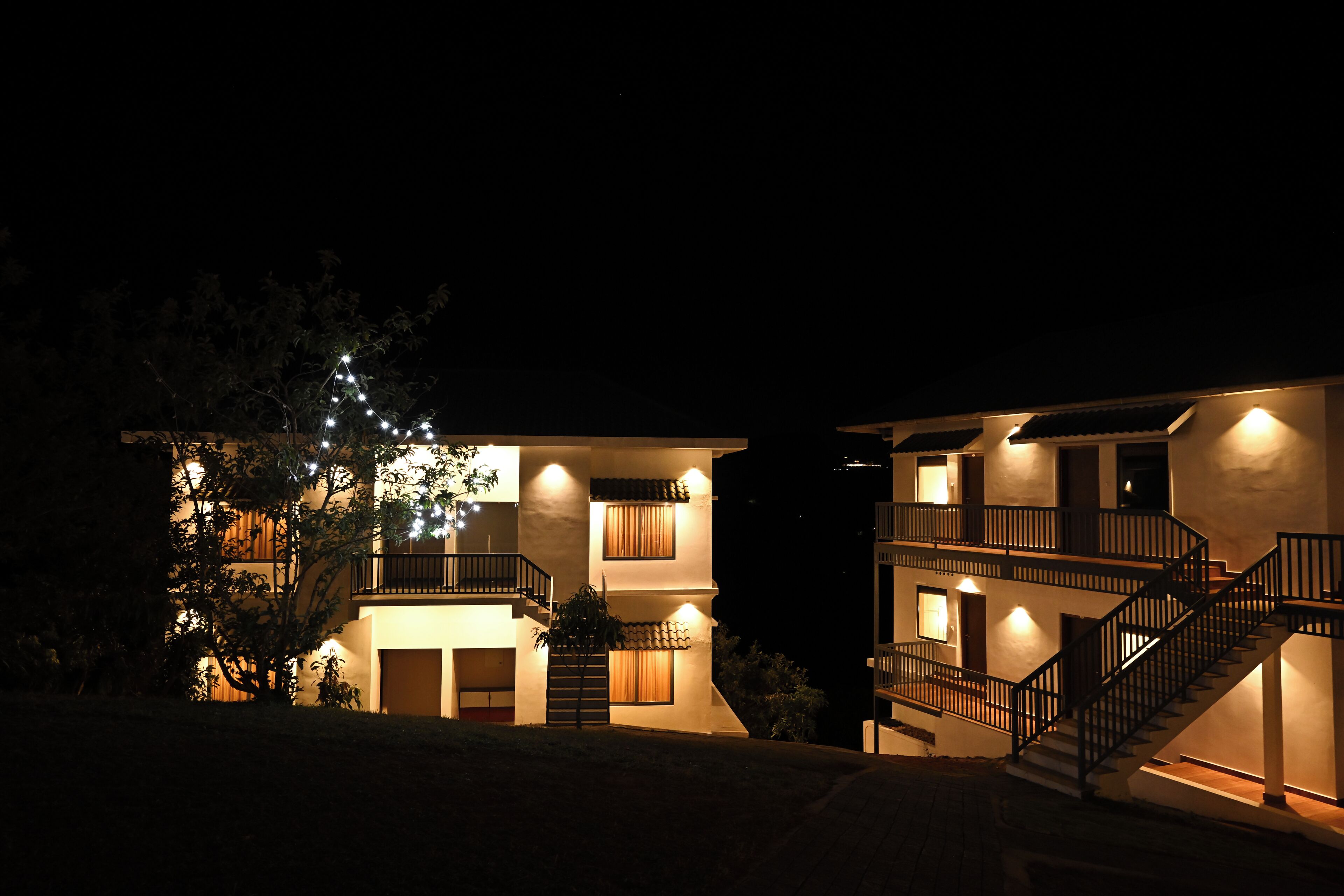 A two-story house with a balcony and a staircase.