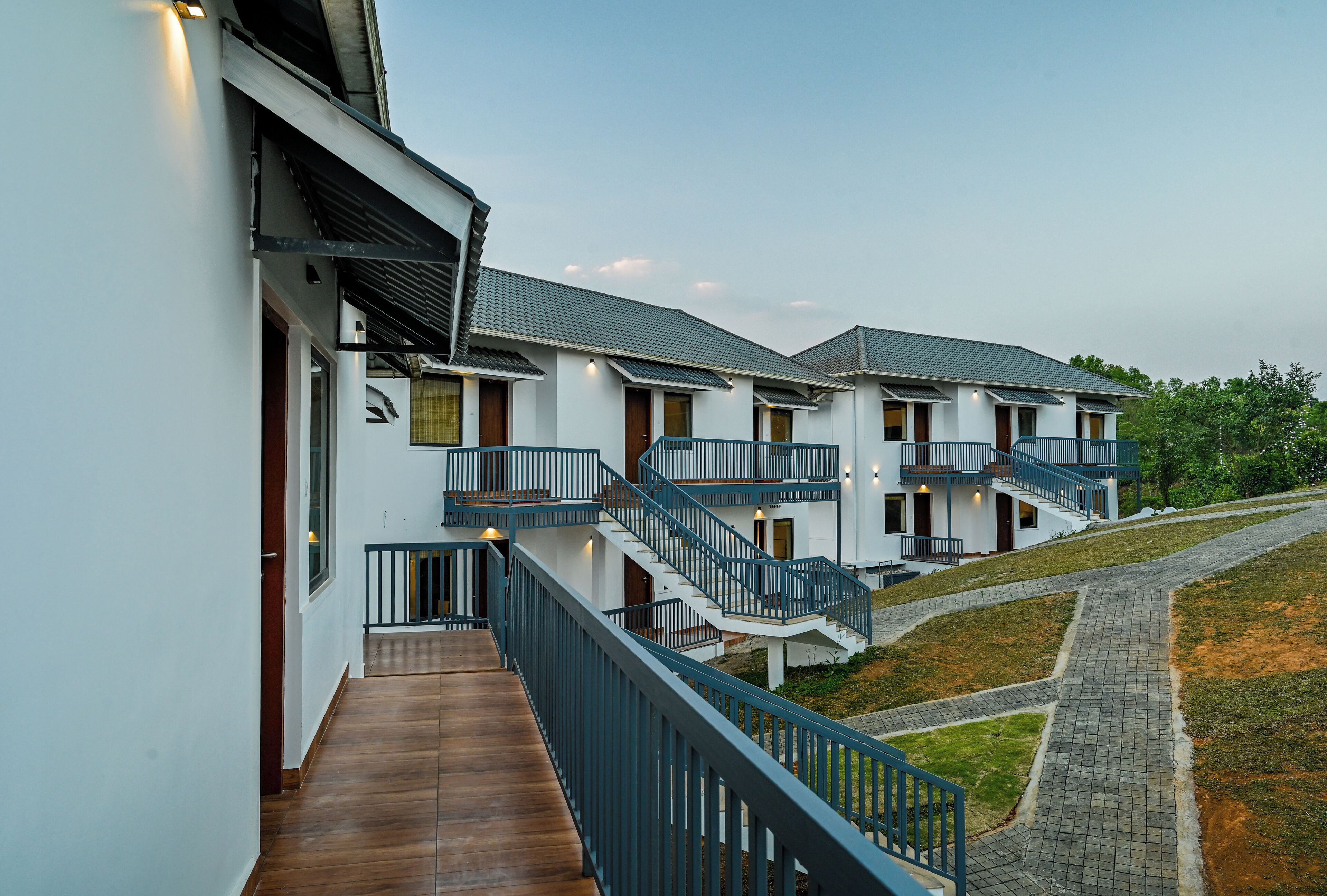 A modern building with multiple balconies and a wooden deck.