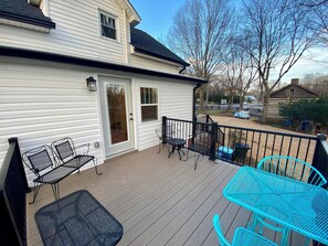 A deck with outdoor furniture, a door, and a view of the surrounding area. - Charming Carolina Cottage in Downtown Mocksville (Mocksville)