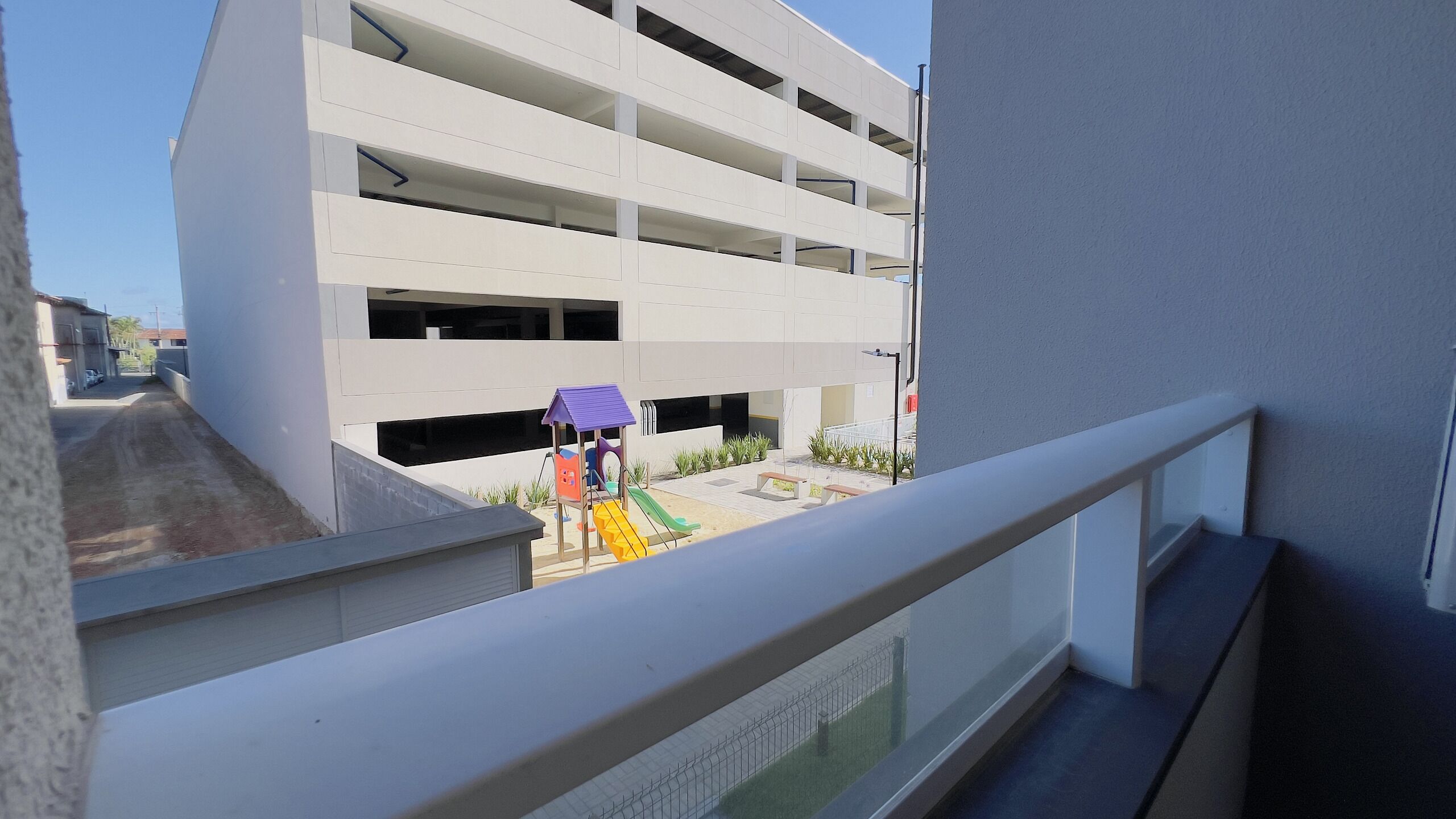 A multi-story parking garage with a children's play area visible through the windows.