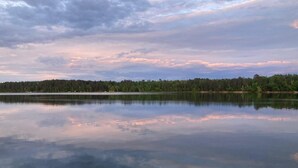 A calm lake with a forested shoreline and a clear sky. - cabin 4 at pleasant ridge resort1bed 1bath lake front on 2nd crow wing lake (Menahga)