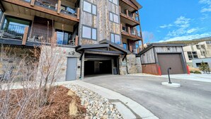 A multi-story building with balconies, a garage, and a driveway. - New Luxury | Keystone Lake | King Bed (Keystone)