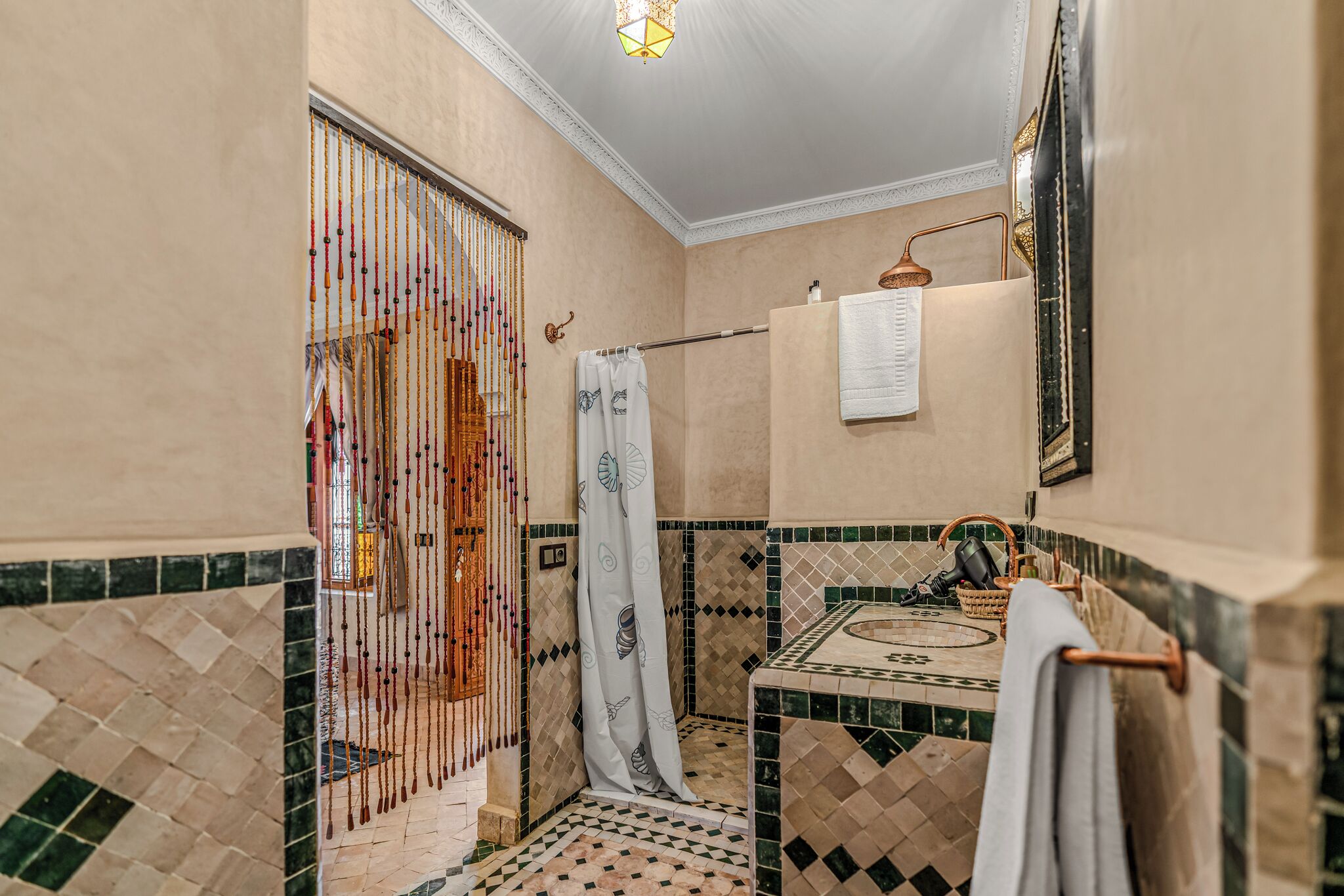 A bathroom with a shower, a towel rack, and a mirror.