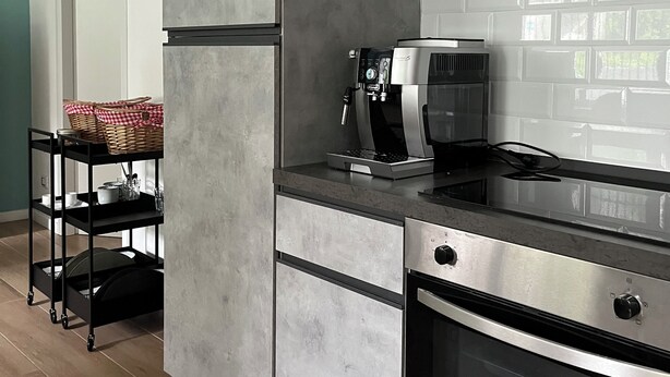 A modern kitchen with grey cabinetry, a built-in oven, a coffee machine, and a black countertop. - B&B Malnati 3 Urban Living Milanosansiro (Milan)