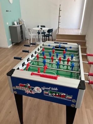 A foosball table with a blue and white design, labeled "Roberto" and "Federazione Italiana Calcio Balilla".