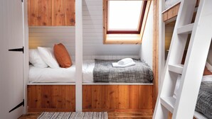 A compact, multi-level room with a loft bed, a small window, and a bunk bed. - Cosy and stylish, dog and family friendly cottage just south of Aviemore (Dalraddy)