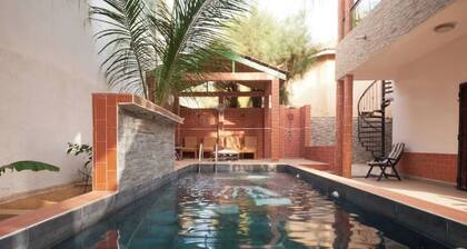 Charming guest room with pool - close to the beach in Grand Mbour