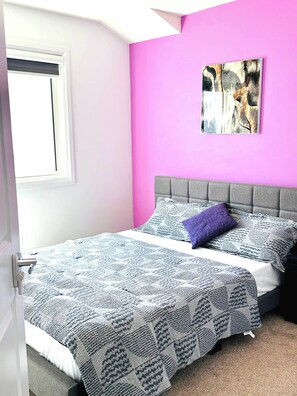 A bedroom with a bed, a window, a pink wall, and a painting. - Modern 3BR Home Edmonton Near by Airport (Edmonton)