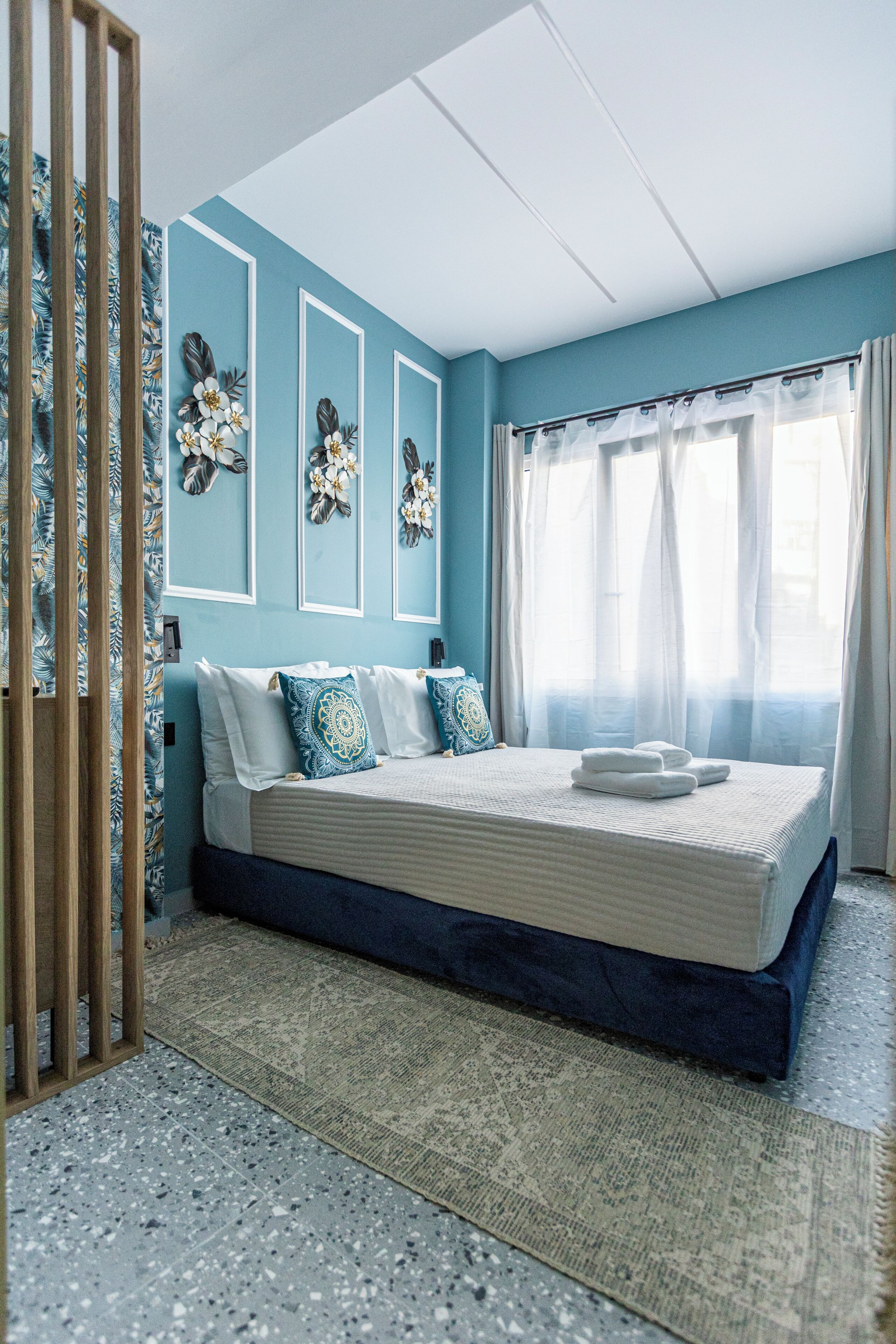 Ein Schlafzimmer mit einem Bett, Vorhängen und Wanddekorationen.