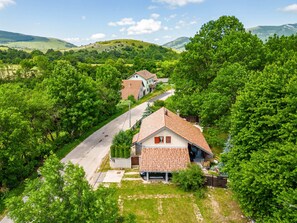 A residential area with houses, a road, and surrounding greenery. - Rural home in nature with jacuzzi, sauna and entertainment amenities (Mazin)