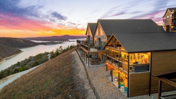 A hotel with a river view, wooden balconies, and a modern design. - Luxury Cabin Private Hot Tub and Steps to Pools! (Kimberling City)
