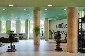 A spacious gym with large windows, exercise equipment, and a wall with the word "UNCLE". - Charles Hope Wembley (Wembley)