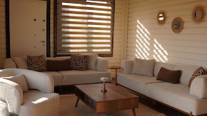 A modern living room with a sofa set, a coffee table, and a small side table. - ON2 Bungalov Villas (Dosemealti)