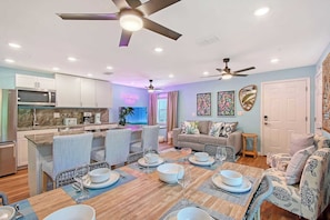 A modern kitchen with a microwave, dining table set for four, and a ceiling fan. - Heated Pool + Slide · 15 Min to Beaches · Sleeps 8 (Bradenton)
