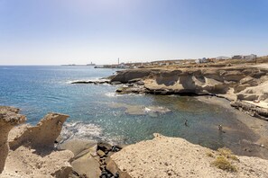 A coastal landscape with rocky terrain and a clear view of the sea. - Home2Book Cozy Sea View Apartment Near the Coast (Arico)