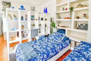 A bedroom with a bed, two bedside tables, a wardrobe, and a shelf with various items. - Lovely Apartment in Beautiful Mogan (Los Pasitos)